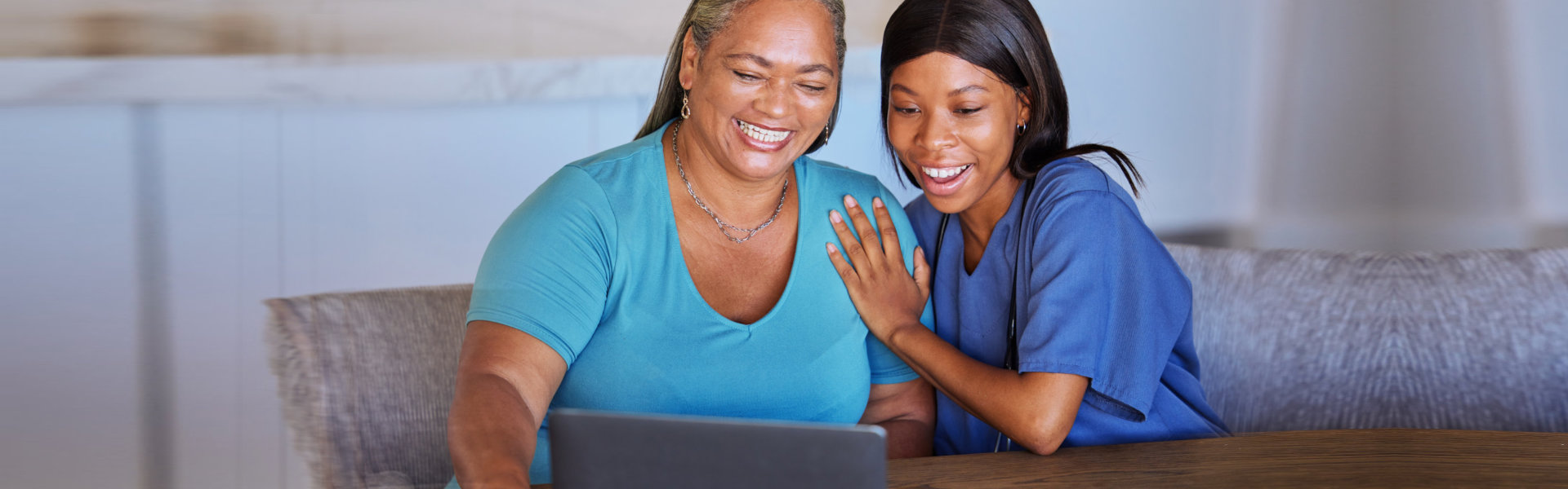 Happy senior woman and caregiver with laptop excited over video call, news or streaming exciting movie. Wow, communication and elderly retirement black woman and nurse in online conversation at home